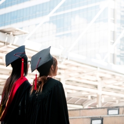 graduate students looking at the ceiling of a building