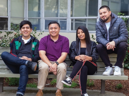 group of students sitting on a bench